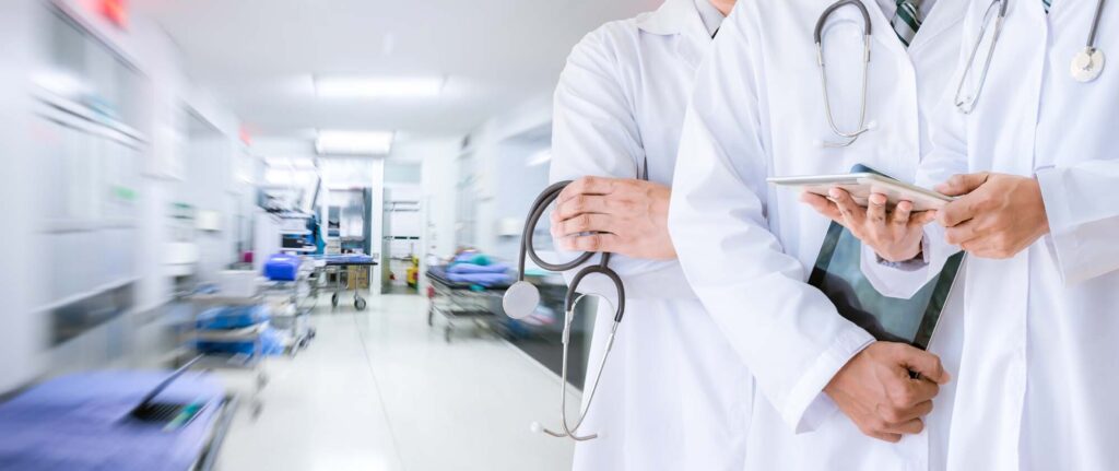 Doctors standing in the long main hallway of a hospital. 